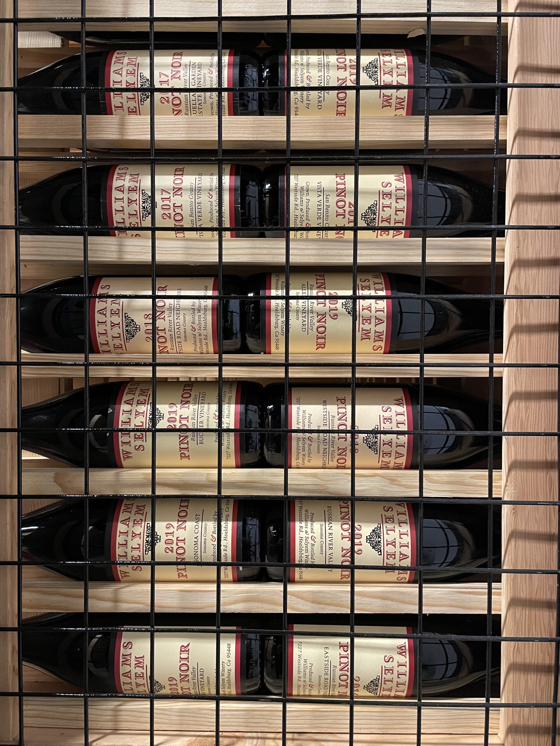 Williams Selyem bottles in our wooden wine racks